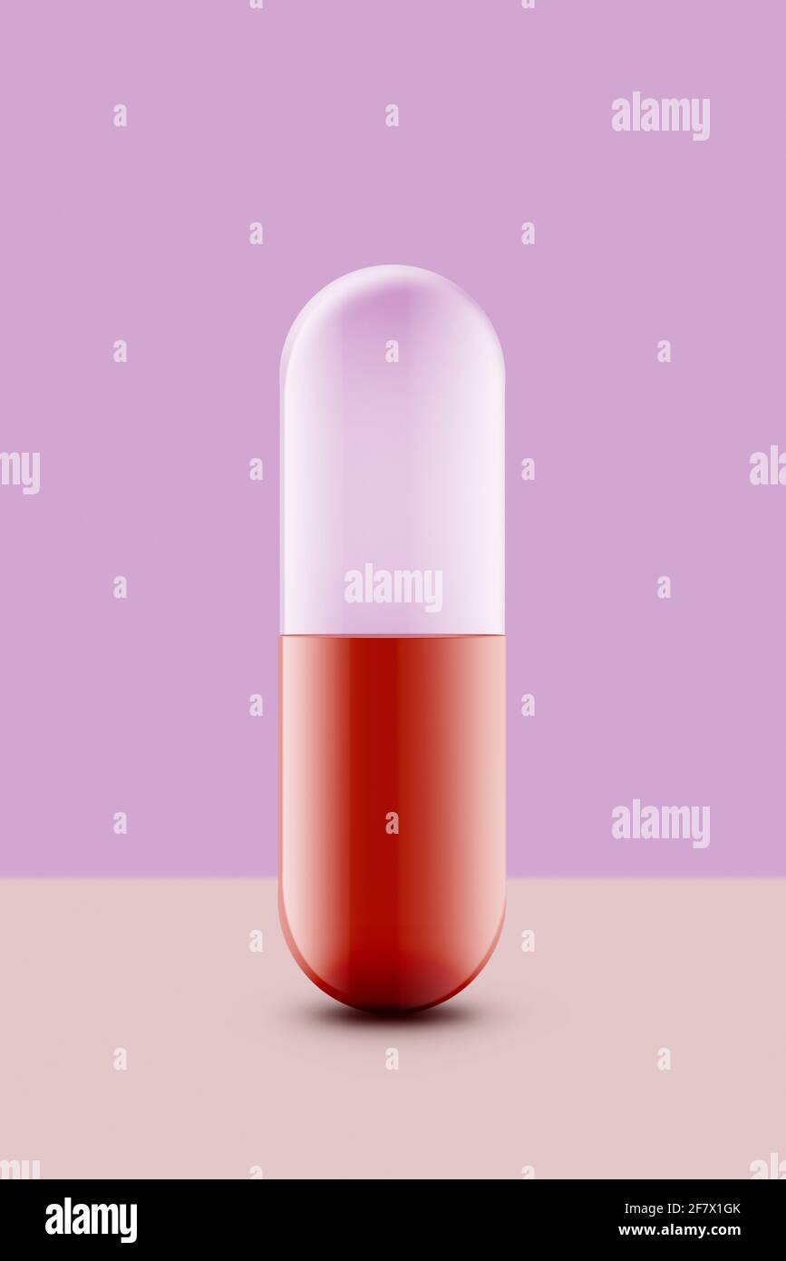capsula medicinale rossa su sfondo colorato. Foto Stock