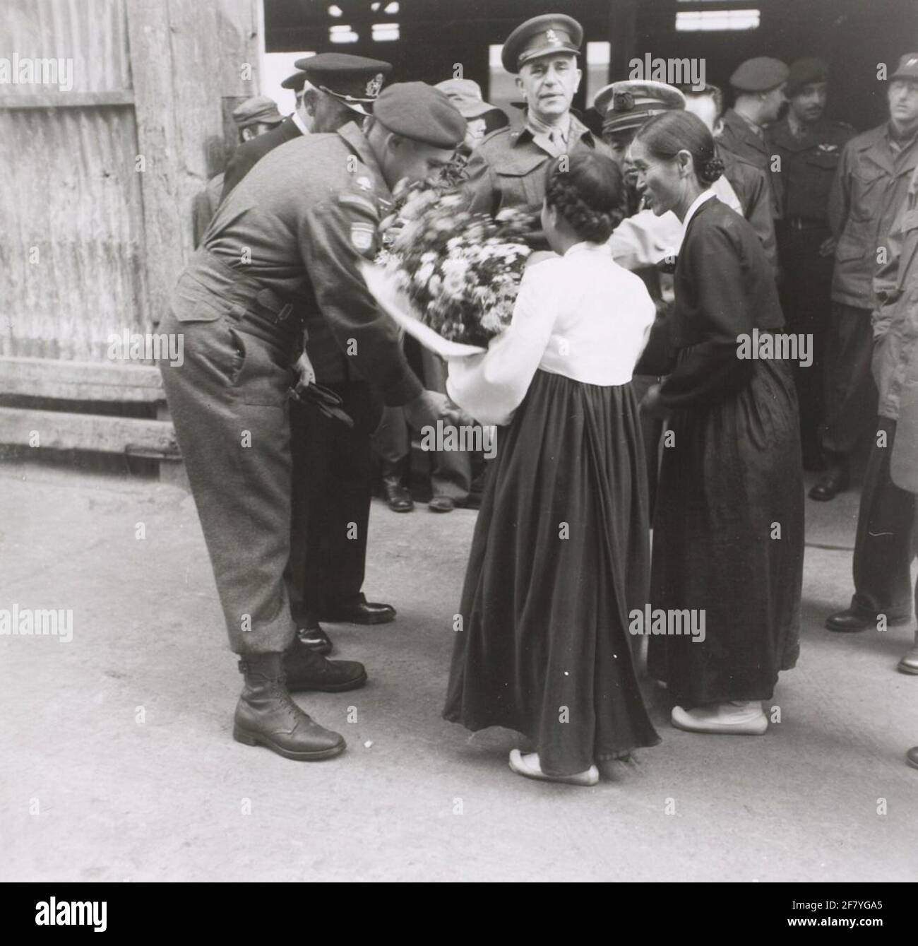 Il comandante delle Nazioni Unite olandesi di Detachement in Corea, il tenente colonnello M.P.A. Den Ouden, riceve fiori da representatori del movimento patriottico delle donne all'arrivo del distacco con la SS Zuiderkruis nel porto di Pusan. Didascalia originale: 'Fiori per quell'uomo!' Il movimento patriottico delle donne accoglie con favore la vecchiaia. Foto Stock
