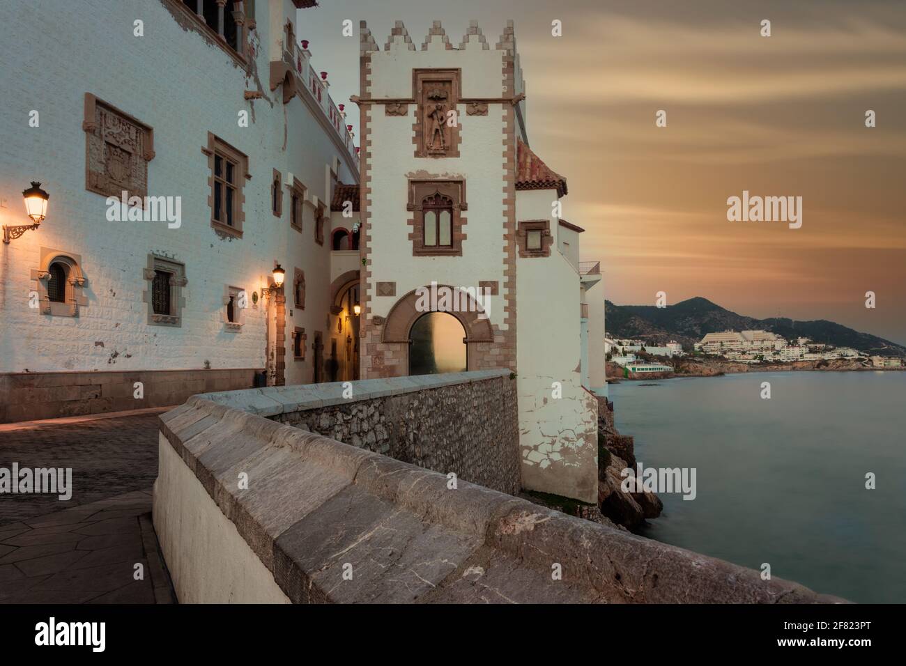 Edifici medievali a Sitges, Catalogna, Spagna con morbido cielo tramonto al tramonto Foto Stock