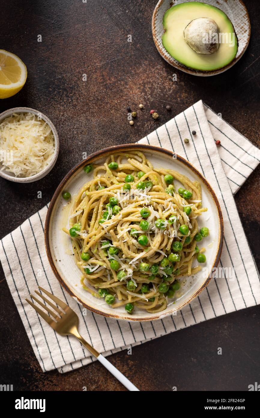 Spaghetti di pasta integrale con piselli verdi e avocado Foto Stock