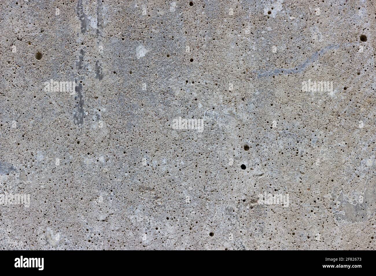 Una superficie piana di cemento grigio con molta minuscola aria bolle Foto Stock