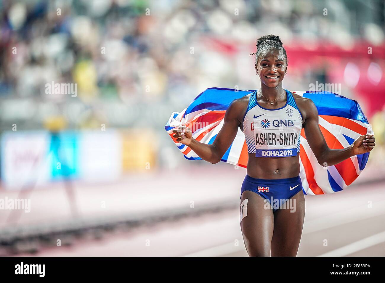 Doha 2019.Dina Asher-Smith festeggia il suo secondo posto con la sua bandiera ai campionati mondiali di atletica di Doha 2019. Foto Stock