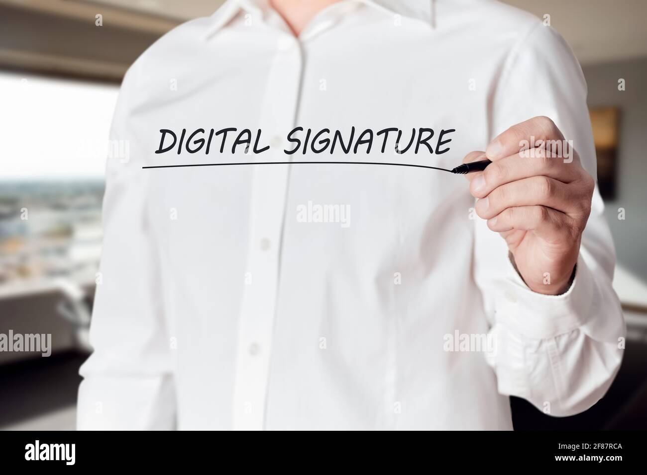 La mano dell'uomo d'affari tiene una penna e sottolinea le parole firma digitale su uno schermo virtuale. Foto Stock