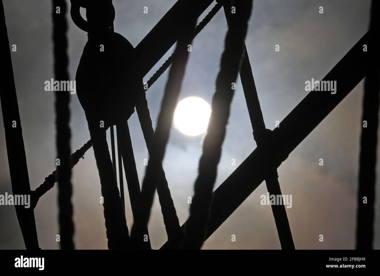 Rostock, Germania. 13 Apr 2021. Il sole splende attraverso la manipolazione della tradizionale nave a vela "Santa Barbara Anna" nel porto della città. La nave funge anche da sfondo marittimo per i passeggini che approfittano del bel tempo primaverile per un'escursione. Credit: Bernd Wüstneck/dpa-Zentralbild/ZB/dpa/Alamy Live News Foto Stock