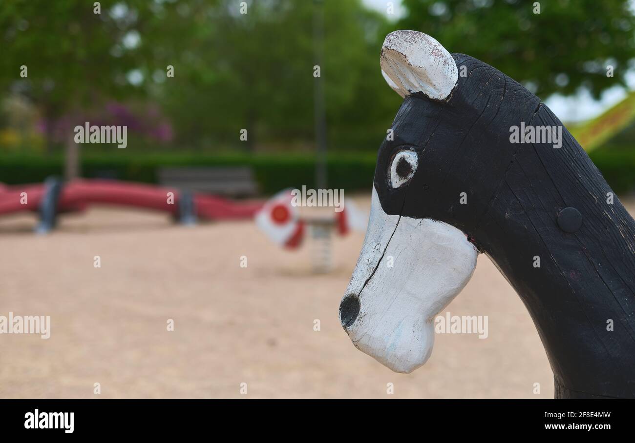 dettaglio della testa di un cavallo da un'altalena in un parco pubblico Foto Stock