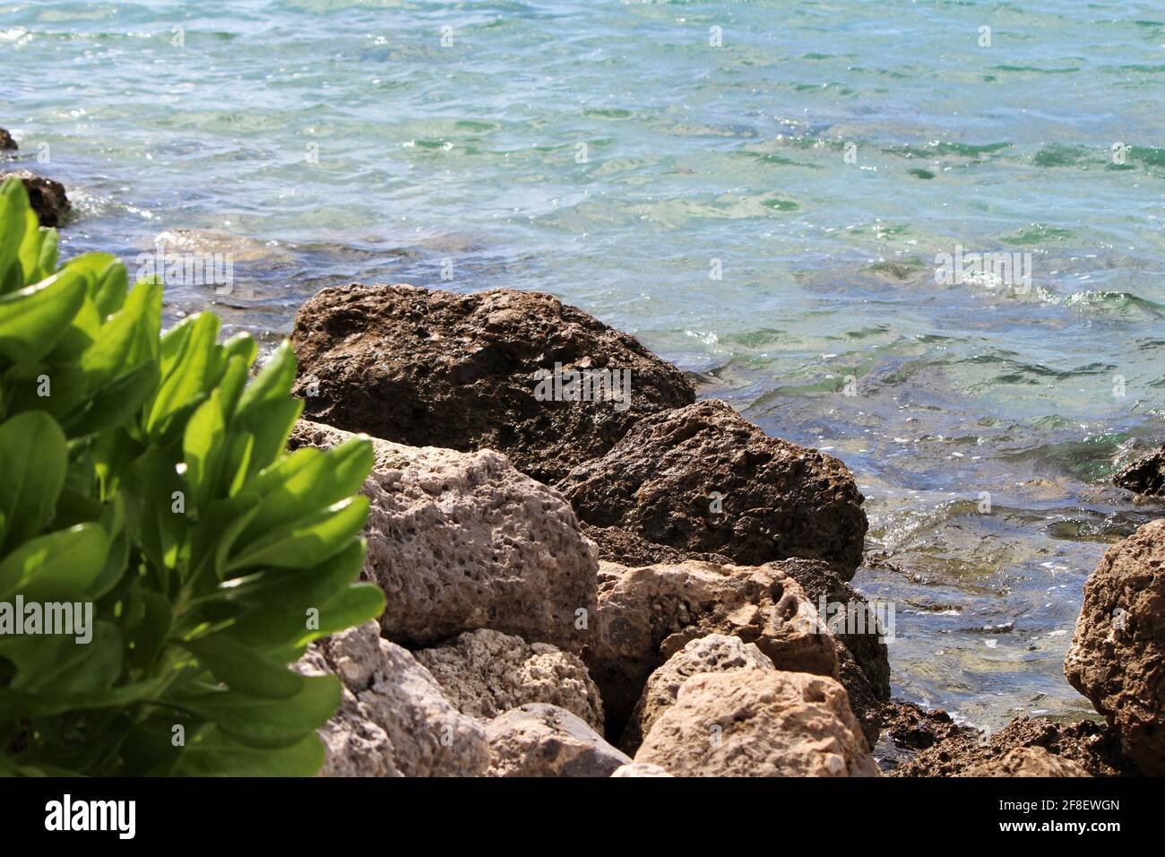 Bellissima acqua cristallina dell'oceano che colpisce le rocce sul South Point Pier Park a Miami Beach, Florida, copyspace Foto Stock