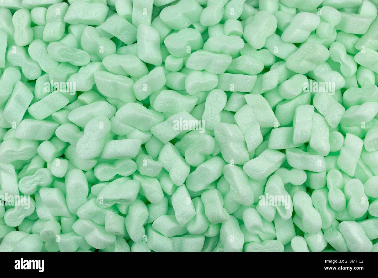 Schiuma di polistirene verde arachidi imballaggio riempitivo materiale ammortizzante Texture sfondo Foto Stock