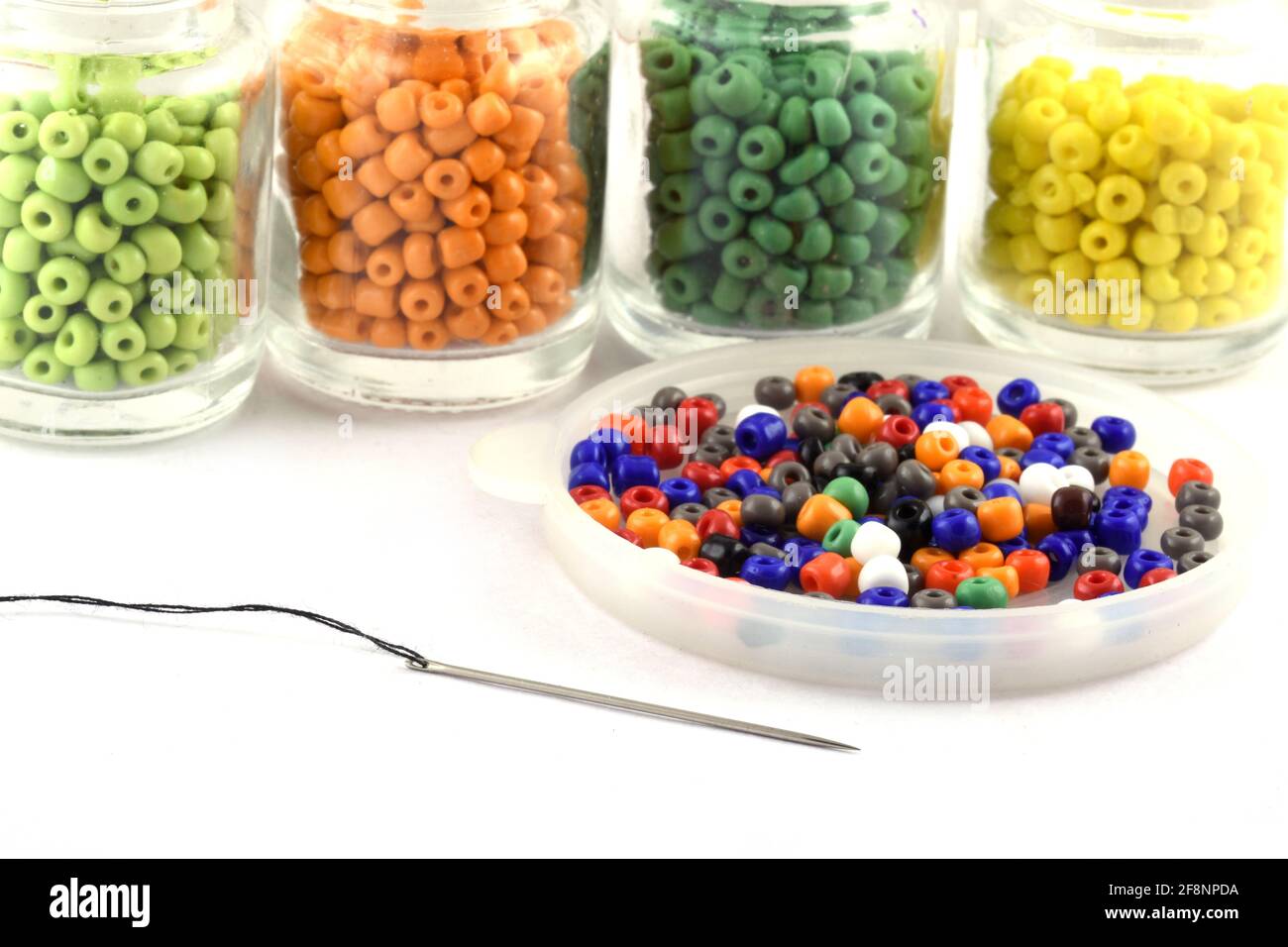 Perline colorate con ago perline in bottiglia usate per rifinire i vestiti di moda fanno collana di perline, perline per donne di moda, perline crochet Daily Beading Foto Stock