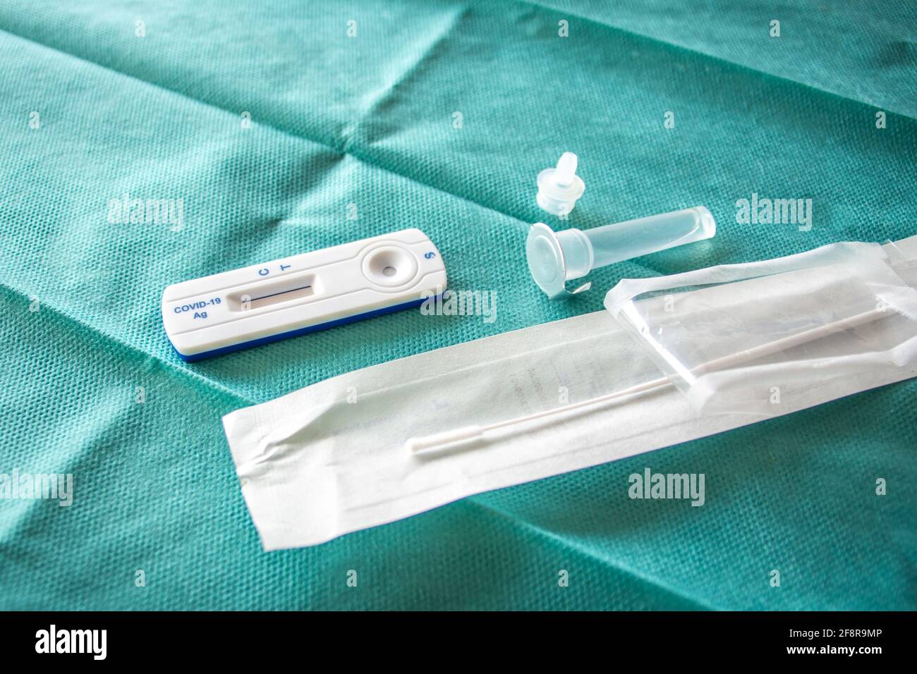 COVID-19 Kit Rapid Antigen Test su fondo chirurgico verde, pronto per l'uso. Concetto di un'ampia strategia di test per far fronte alla pandemia. Foto Stock