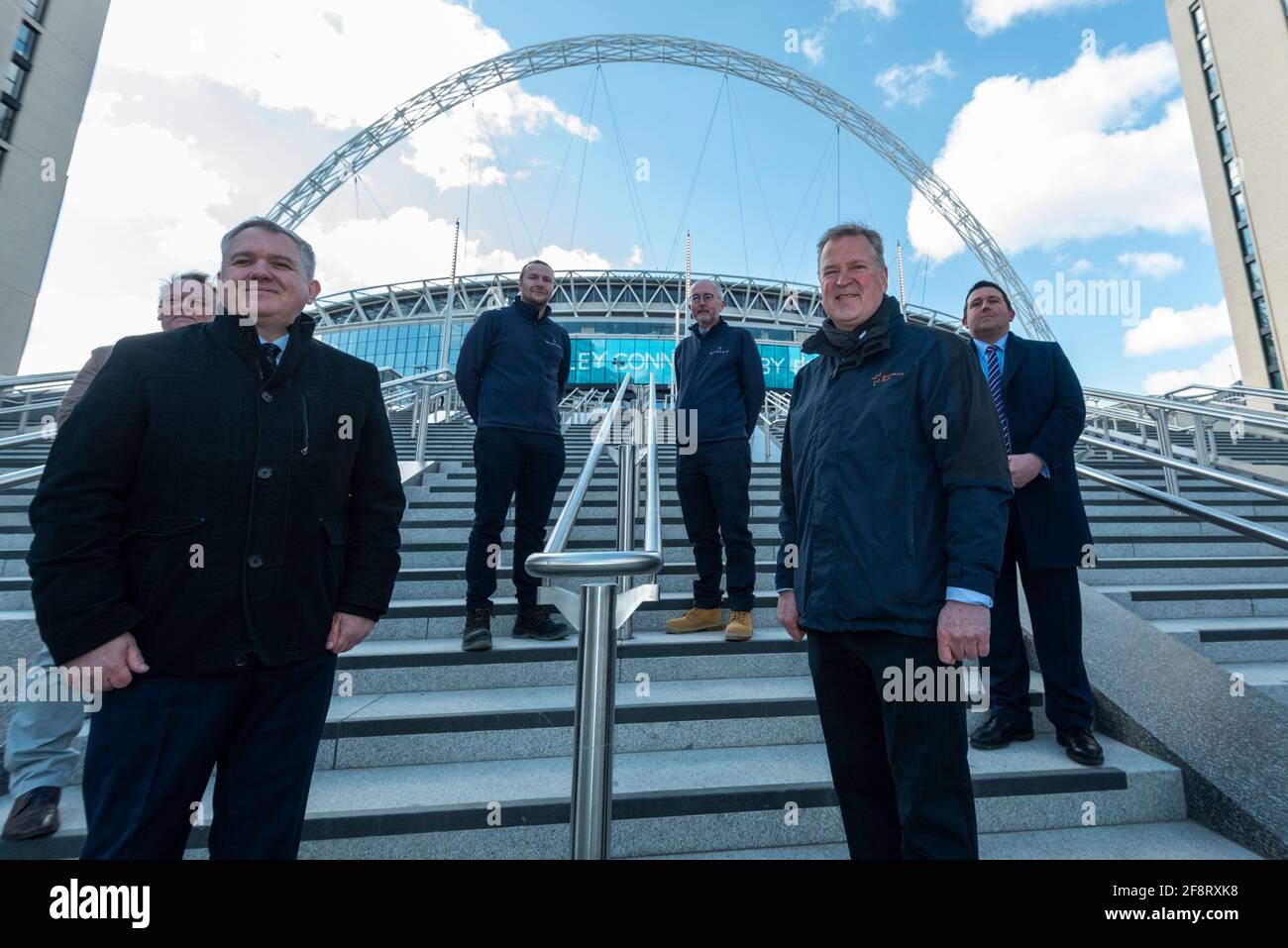 Londra, Regno Unito. 15 aprile 2021. (Prima fila, da L a R) Stephen Daniels, direttore delle operazioni, e James Saunders, amministratore delegato di Quintain di fronte ai dirigenti della fotocellula sulla prossima fase olimpica di Wembley Stadium. La scalinata olimpica 48 comprende 4 voli di 12 gradini e diventerà la nuova porta di accesso allo stadio per i visitatori e i tifosi che arrivano dalla Olympic Way e sarà completata nel giugno 2021 in tempo per le partite di gruppo in Inghilterra a Euro 2020. Credit: Stephen Chung / Alamy Live News Foto Stock