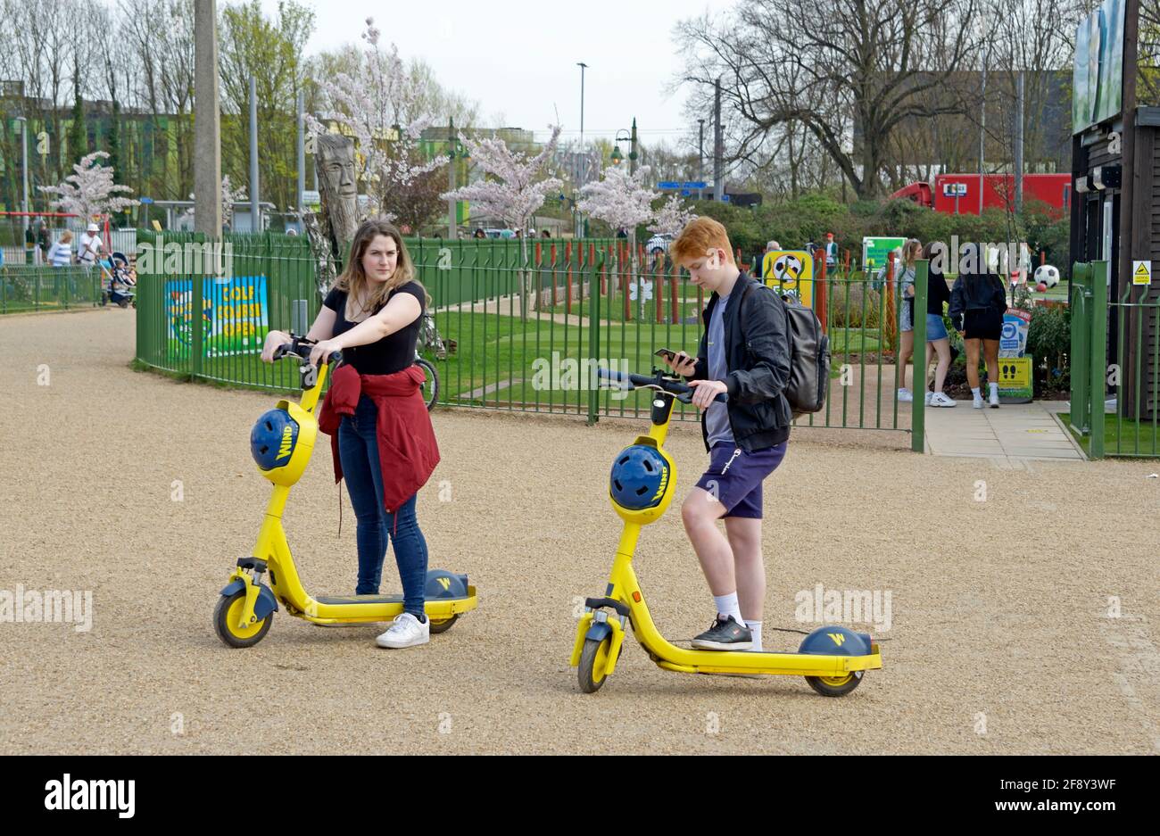 Giovane coppia con scooter elettrici noleggiati. Foto Stock