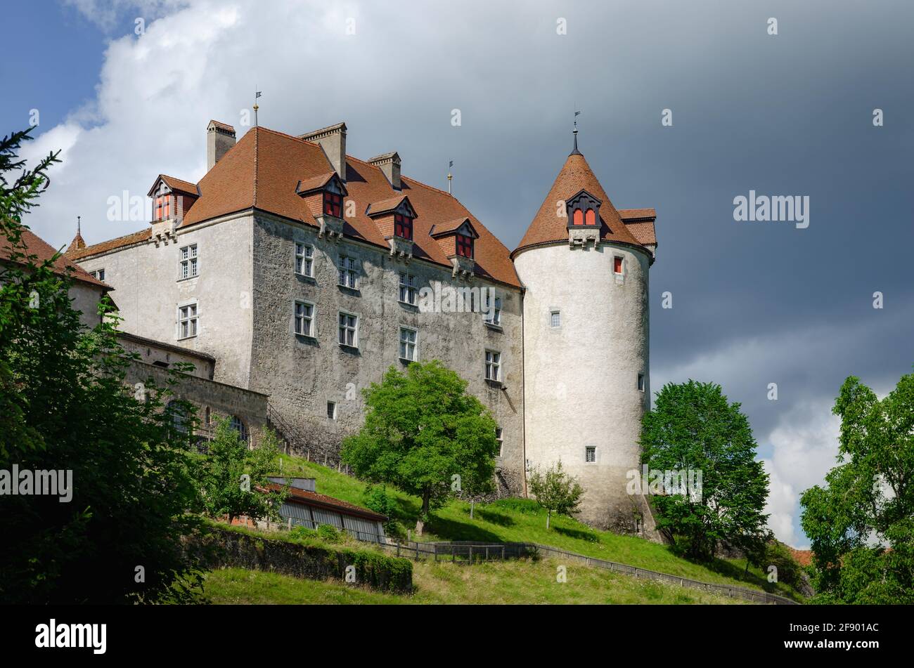 Vista esterna del villaggio di Gruyeres, famosa città casearia della svizzera. Dettaglio del suo castello medievale con sfondo nuvoloso Foto Stock