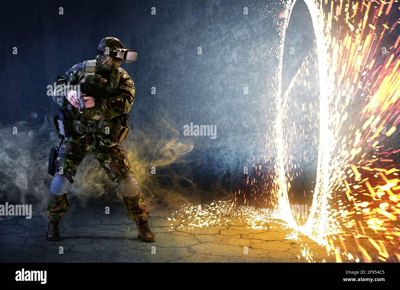 Un soldato con occhiali di realtà virtuale guarda l'anello del fuoco e tiene una pistola nelle sue mani. Il concetto di realtà virtuale. Giochi di simulazione. Foto Stock