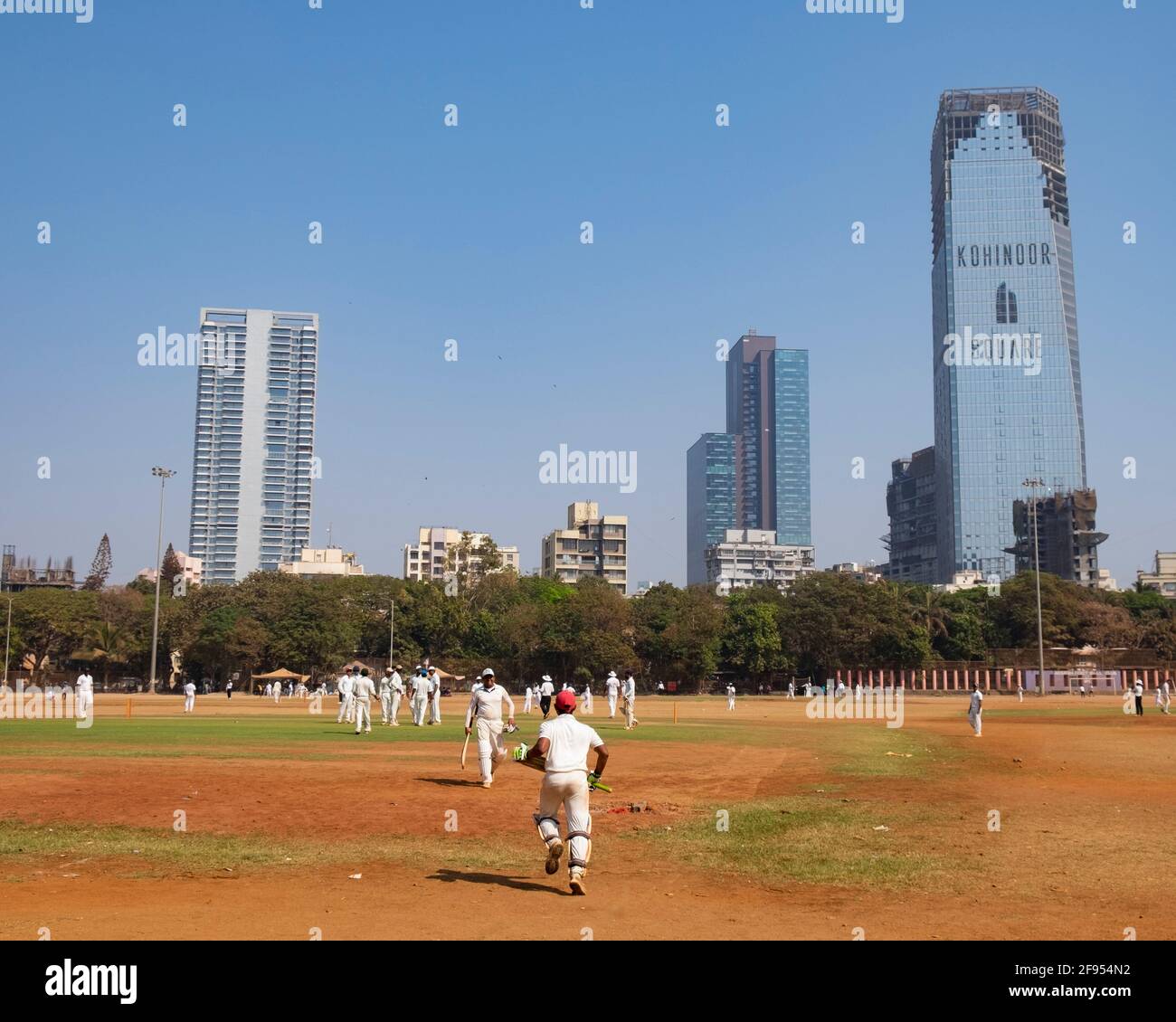 Cricket batman che cammina sul campo nel Parco Shivaji a Mumbai-Dadar, India Foto Stock