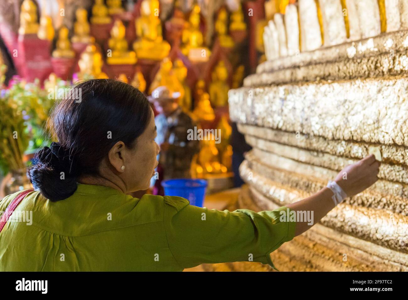 Myanmar, scene al lago Inle, le grotte di Pindaya con la Pagoda Shwe U min, donna, gesto Foto Stock