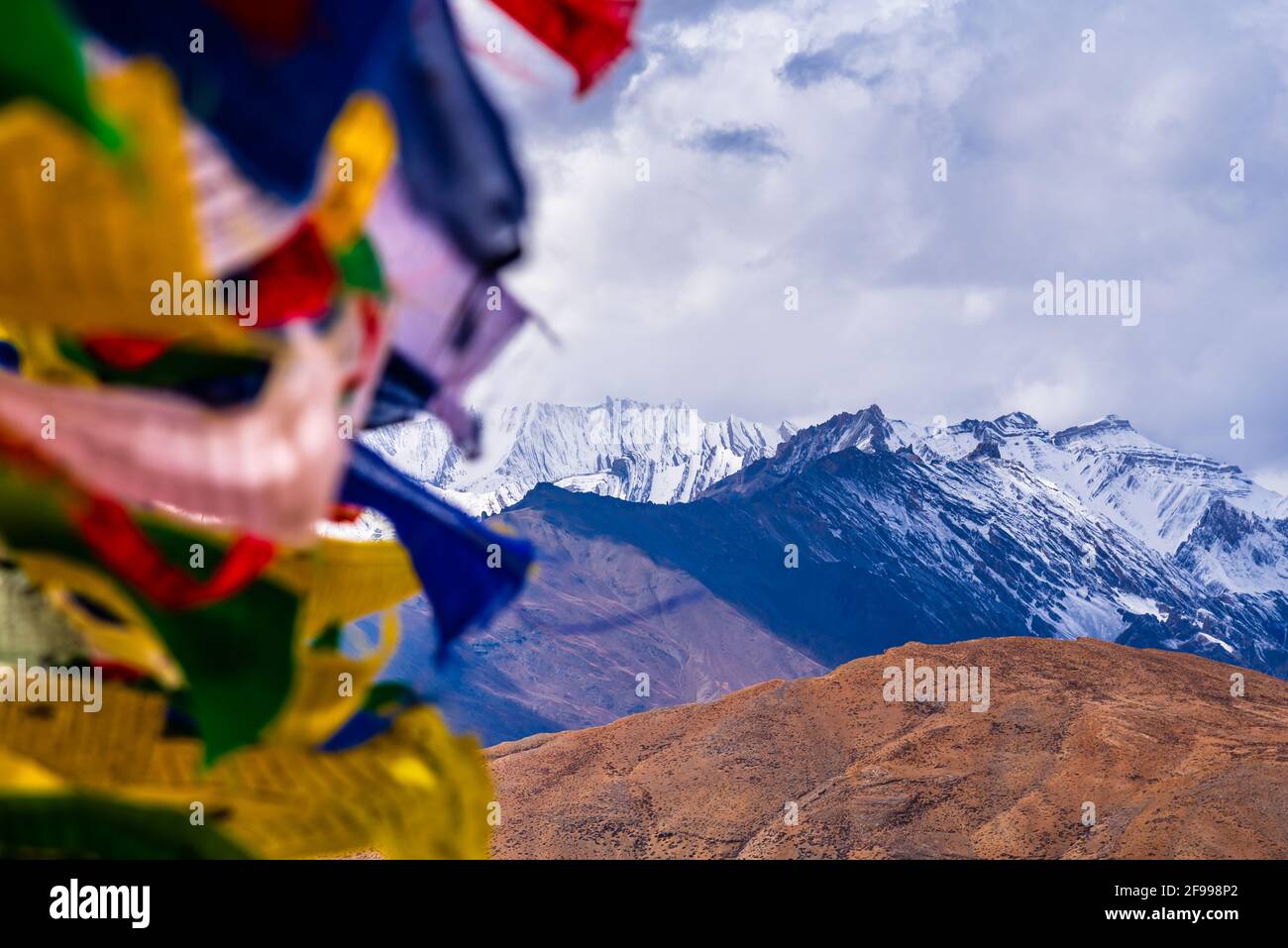 Bandiere di preghiera colorate che volano in venti con le montagne di Himalaya al villaggio di Komic della Valle di Spiti, Himachal Pradesh, India. Foto Stock