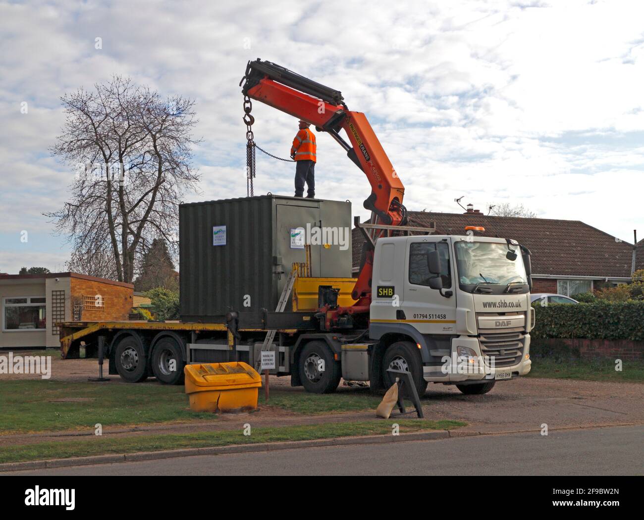 Un'unità mobile temporanea in fase di preparazione per essere scaricata da un veicolo di trasporto vicino ad un cantiere di Hellesdon, Norfolk, Inghilterra, Regno Unito. Foto Stock