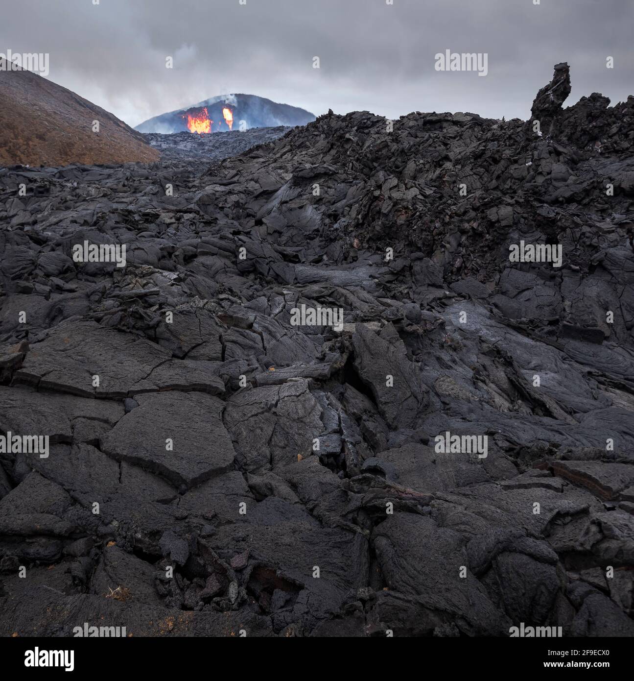 Primo piano fiumi magma solidificati del vulcano Fagradalsfjall in Islanda in una giornata nuvolosa Foto Stock