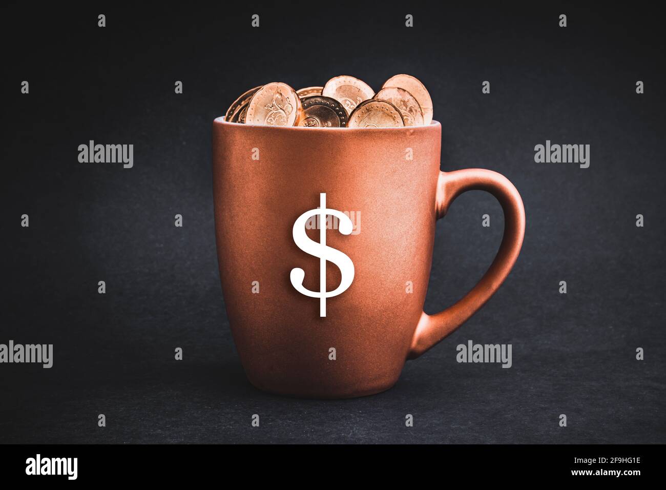SIMBOLO DEL DOLLARO CON monete in tazze su sfondo nero. Concetto di imposta, risparmio, profitto e investimento Foto Stock