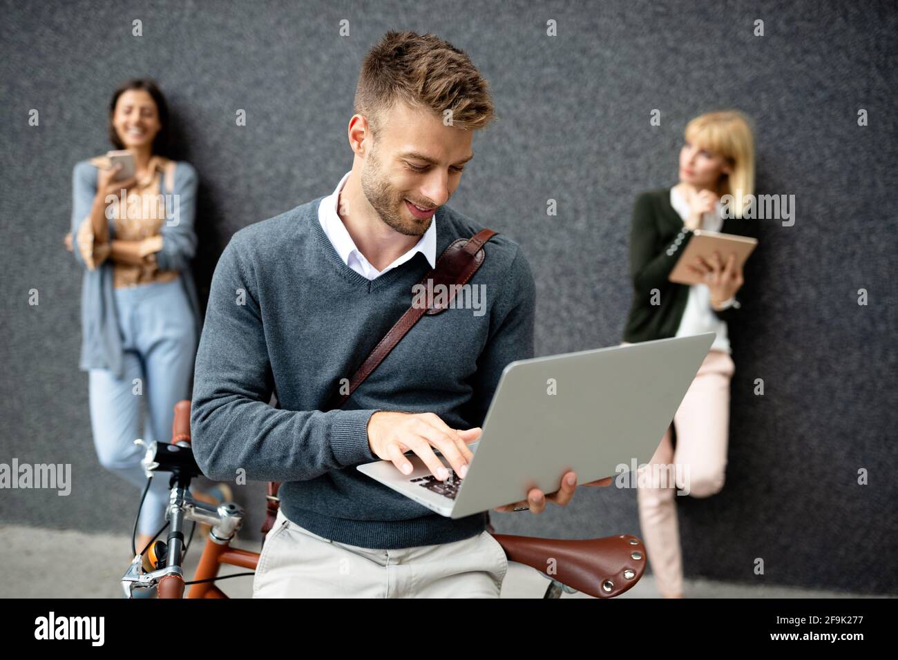 Gruppo di persone aziendali che utilizzano dispositivi elettronici all'aperto Foto Stock