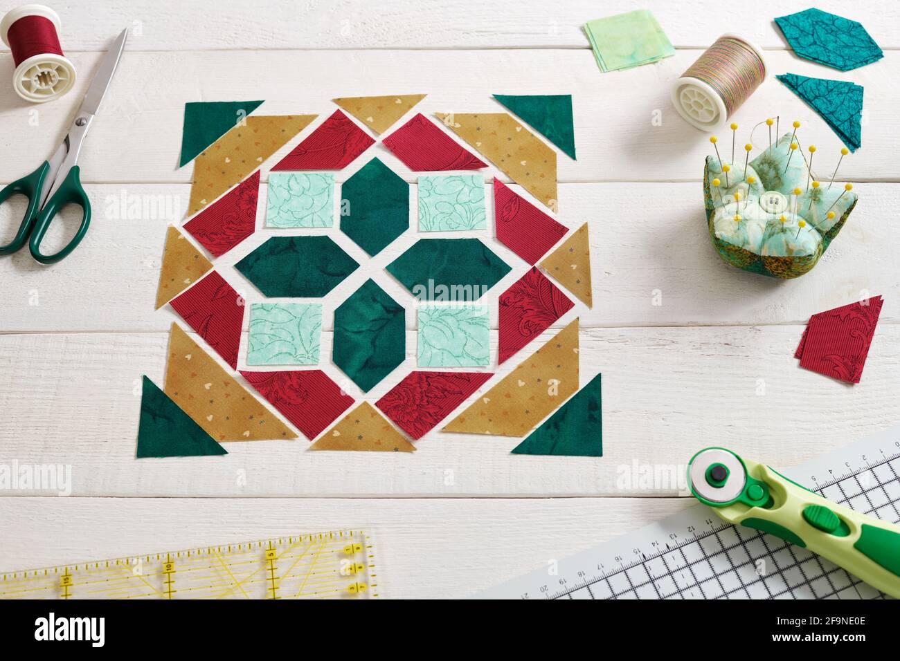 Pezzetti di tessuto disposti a forma di blocco di patchwork, accessori per cucire e trapuntare. Trapuntatura tradizionale. Foto Stock