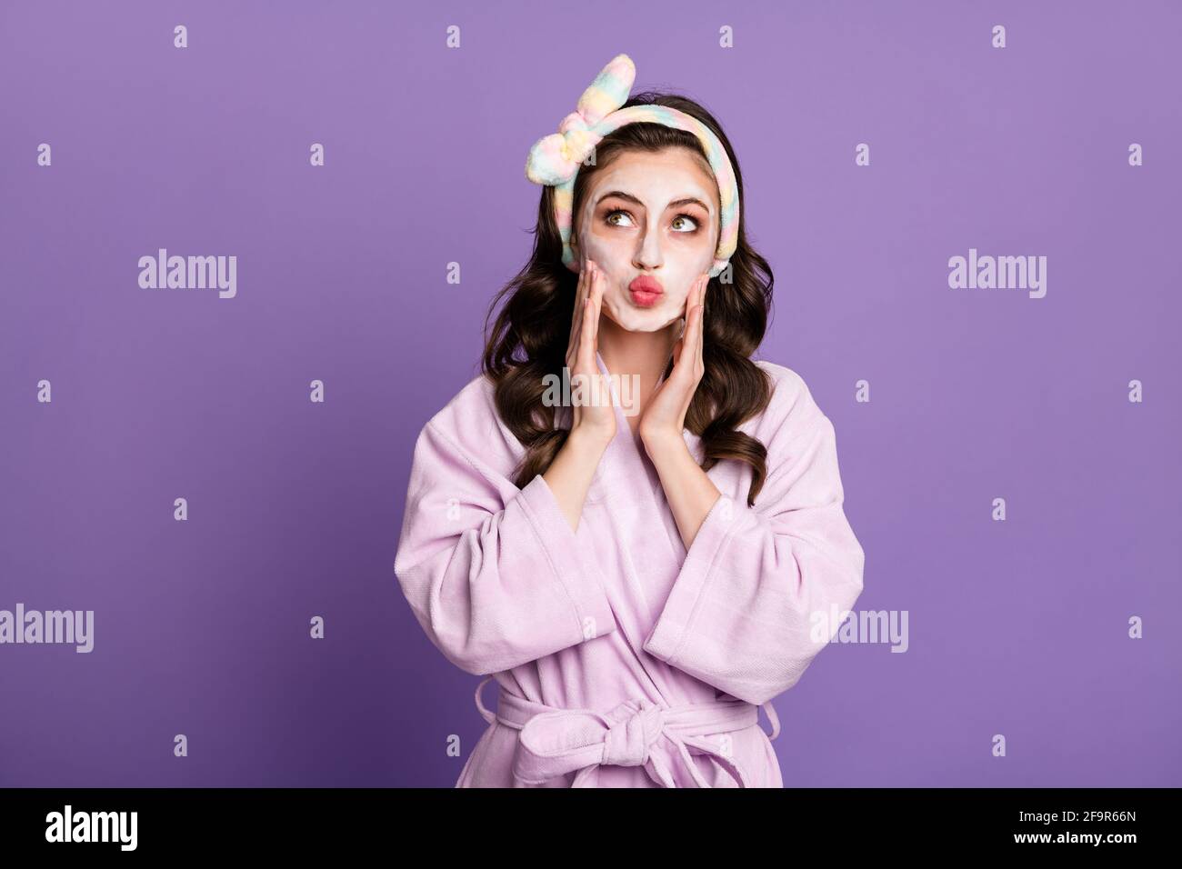 Ritratto fotografico di ragazza sognante che pulisce la pelle con aspetto in schiuma allo spazio vuoto inviando bacio d'aria isolato su violetto vivido sfondo a colori Foto Stock