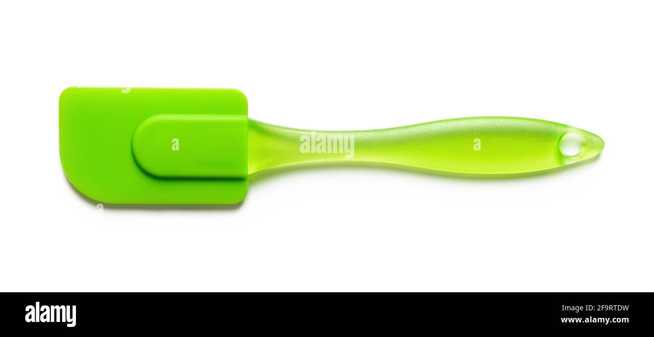 Spatola in silicone verde isolata su fondo bianco. Nuova spatola in gomma con manico in plastica per pasticceria, pasticceria e pasticceria. Utensile resistente al calore Foto Stock