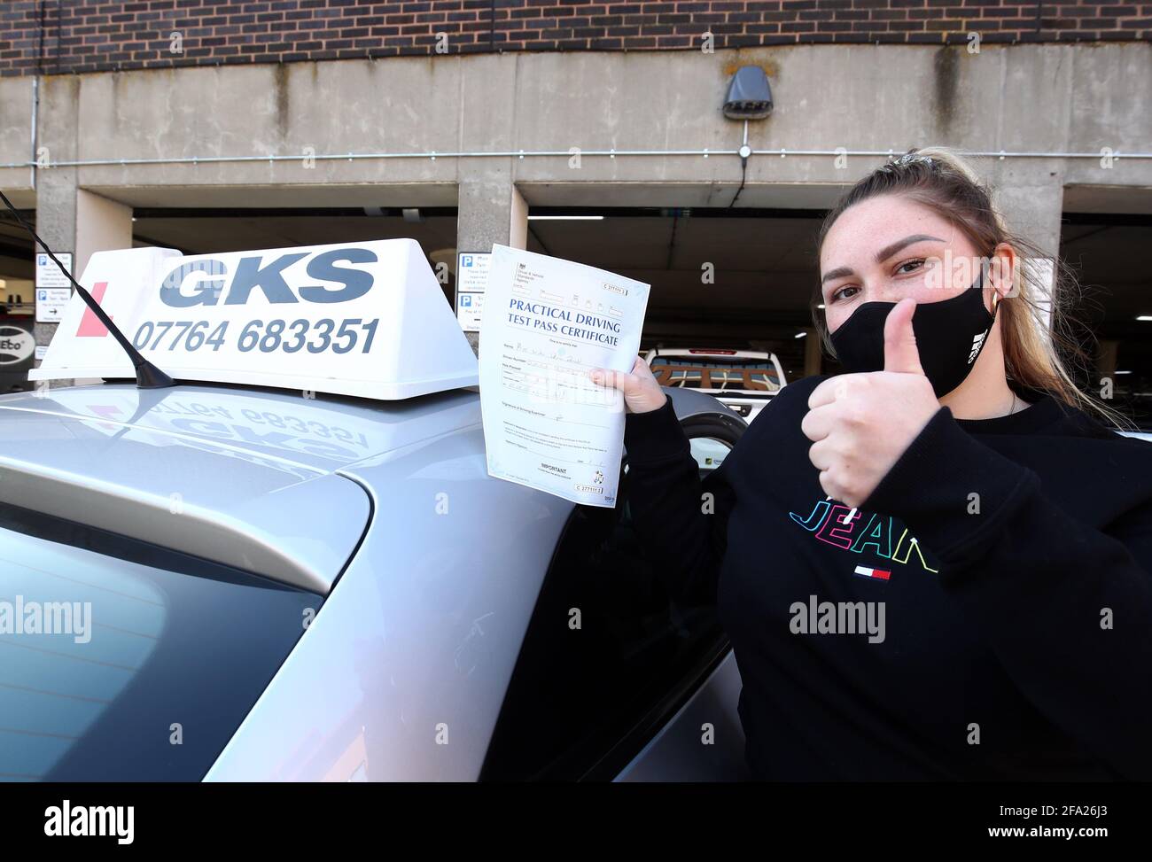 India Donald festeggia il superamento del test di guida presso un centro di test ad Ashford, Kent, dove gli esami sono ripresi in seguito all'ultimo allentamento delle restrizioni di blocco. I test di guida sono stati sospesi in tutto il Regno Unito dall'inizio di gennaio, ma ricominciare oggi in Inghilterra e Galles. Data immagine: Giovedì 22 aprile 2021. Foto Stock