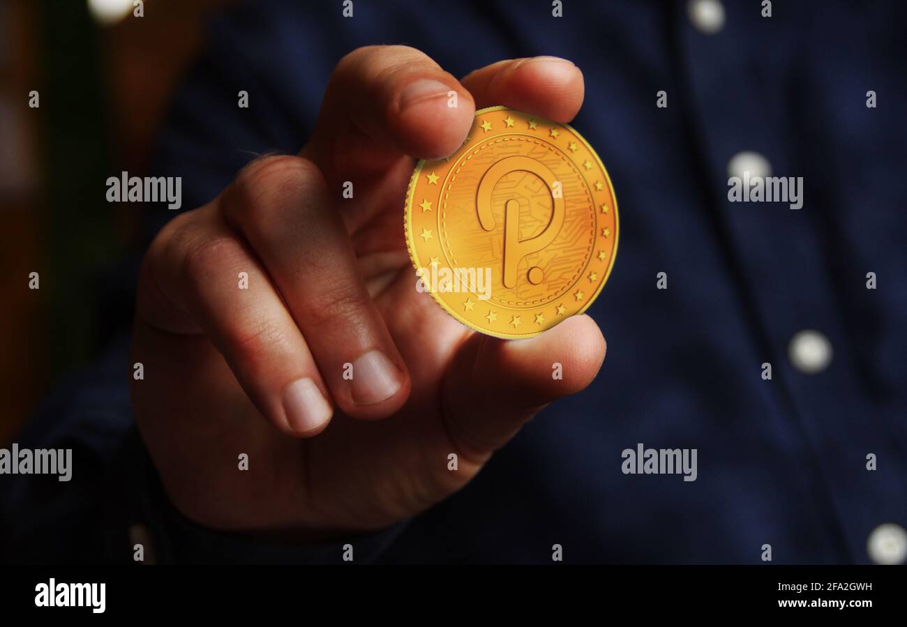 Polkadot criptovaluta simbolo moneta d'oro in mano concetto astratto. Foto Stock