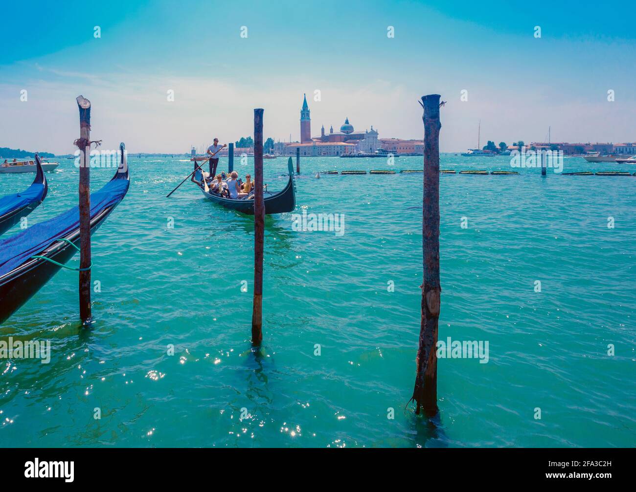 Venezia, Provincia di Venezia, Regione Veneto, Italia. Gondole nel Bacino di San Marco. San Giorgio maggiore alle spalle. Venezia e la sua laguna sono una W UNESCO Foto Stock