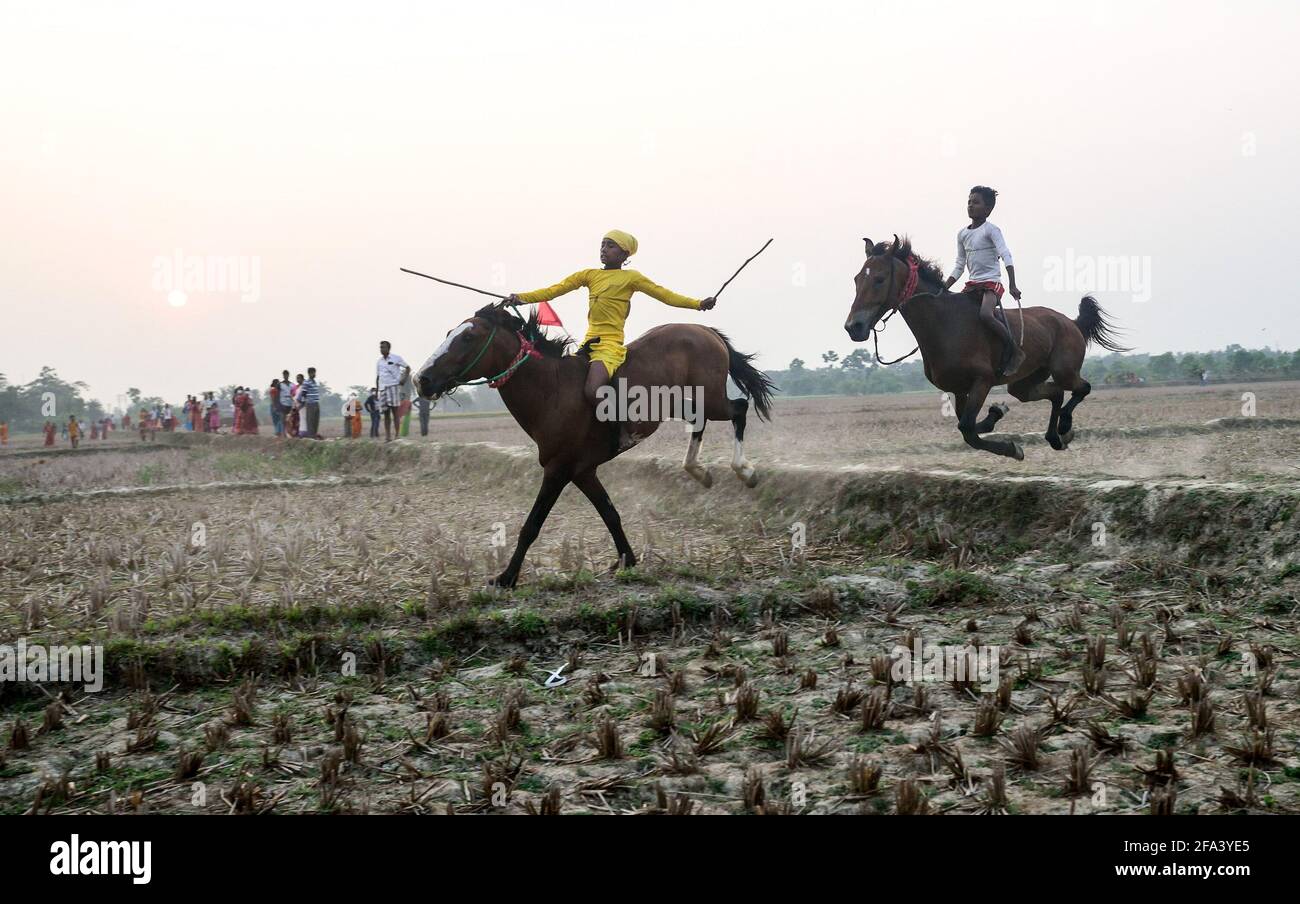 I bambini scacquando cavalcano i cavalli senza gli attrezzi di sicurezza adeguati durante una corsa del cavallo nel Bengala rurale. (Foto di Sumit sanyal/SOPA Images/Sipa USA) Credit: Sipa USA/Alamy Live News Foto Stock