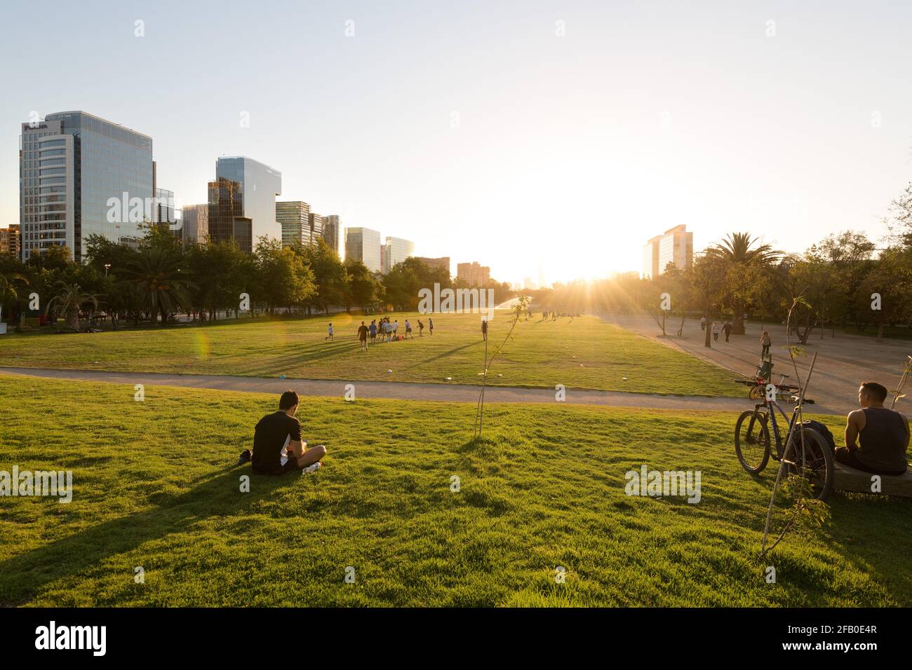 Santiago, Regione Metropolitana, Cile - persone che guardano il tramonto al Parque Arauciano, il parco principale del quartiere di Las Condes. Foto Stock