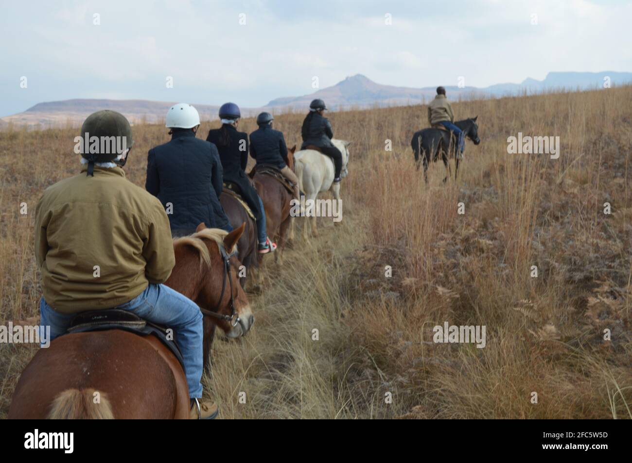 Gruppo di indiani equitazione piloti su un sentiero nella regione di Drakensberg in Africa Foto Stock