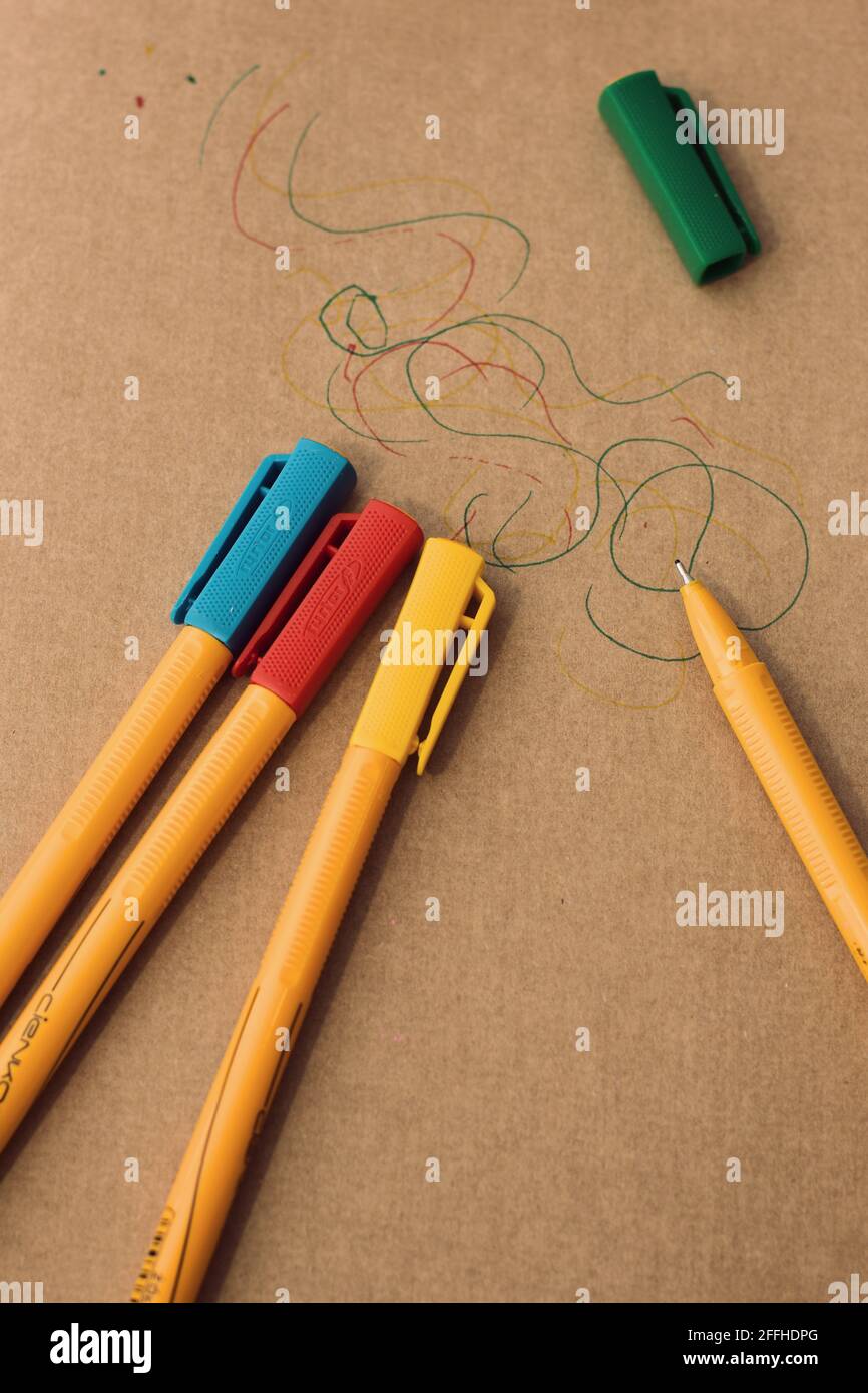 Primo piano di pastelli/pastelli a olio colorati su carta marrone con un semplice schizzo. Concentrati sull'arte, la creatività e l'infanzia Foto Stock