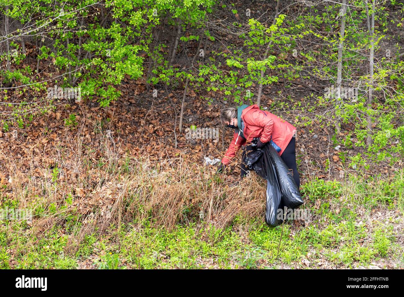 Detroit, Michigan, Stati Uniti. 24 Apr 2021. I volontari ripuliscono i rifiuti dal percorso Dequindre Cut Greenway, che si trova a piedi o in bicicletta, come parte della pulizia primaverile della settimana della Terra. Credit: Jim West/Alamy Live News Foto Stock