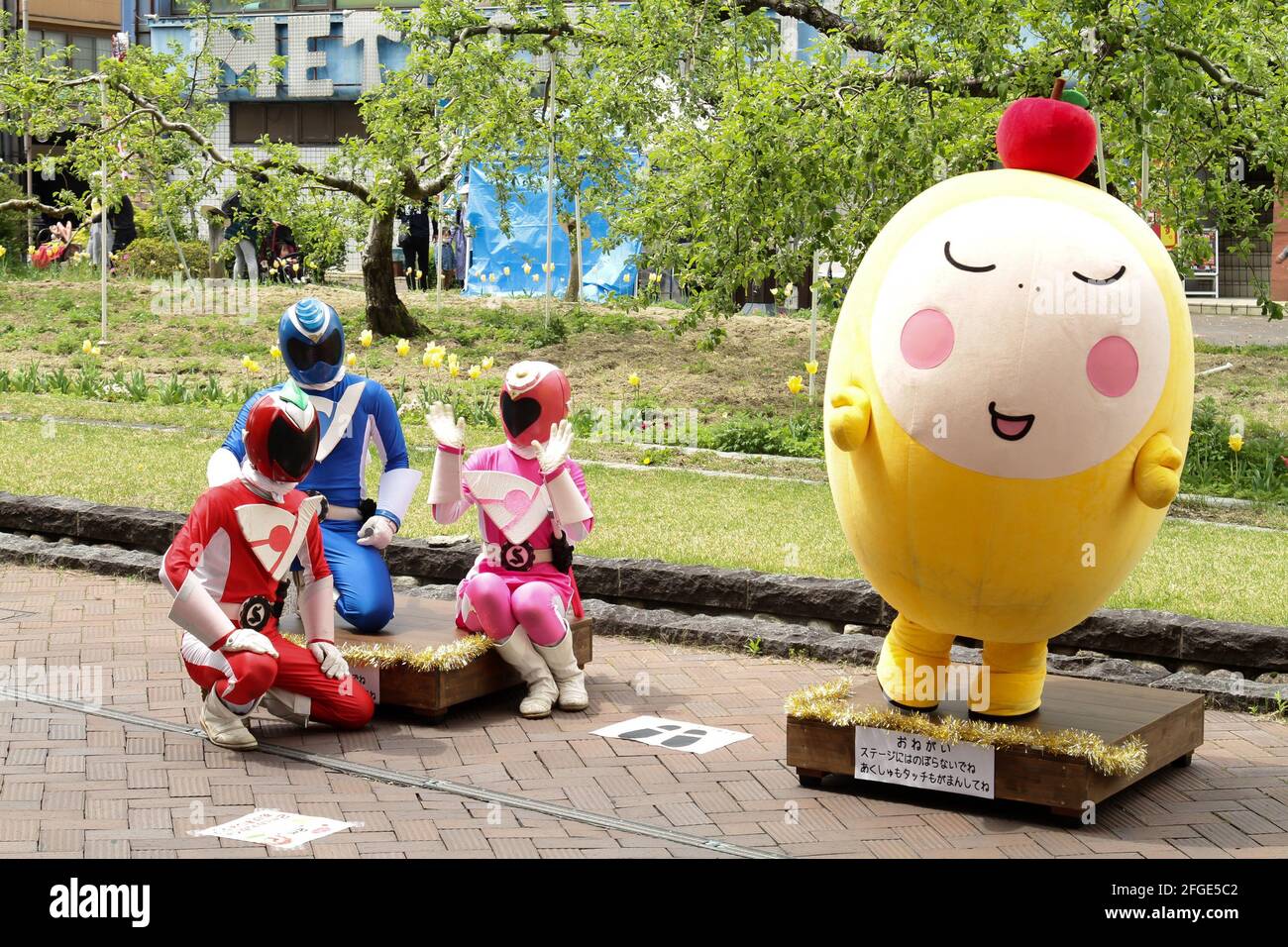 iida, Nagano, Giappone, 25-04-2021 , un gruppo di artisti che indossano una maschera cosplay che pone per i bambini durante un evento nel centro di Iida. Foto Stock