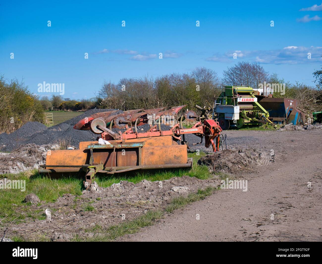 Macchinari agricoli scartati e arrugginiti in campagna a Solway, Cumbria, Regno Unito. Una giornata di sole in primavera. Foto Stock