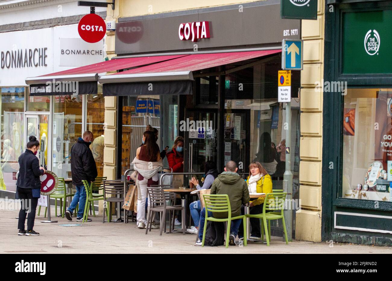 Dundee, Tayside, Scozia, Regno Unito. 26 Apr 2021. Tempo nel Regno Unito: Mattina fredda in tutto il nord-est della Scozia con temperature che raggiungono i 9°C. Il primo giorno di Covid-19 rilassato blocco con la gente alleviato che non-essenziale negozi al dettaglio hanno riaperto oggi nel centro della città di Dundee. I clienti locali approfittano del nuovo e rilassato regolamento di blocco per gustare spuntini e caffè al Costa Coffee Shop. Credit: Dundee Photographics/Alamy Live News Foto Stock