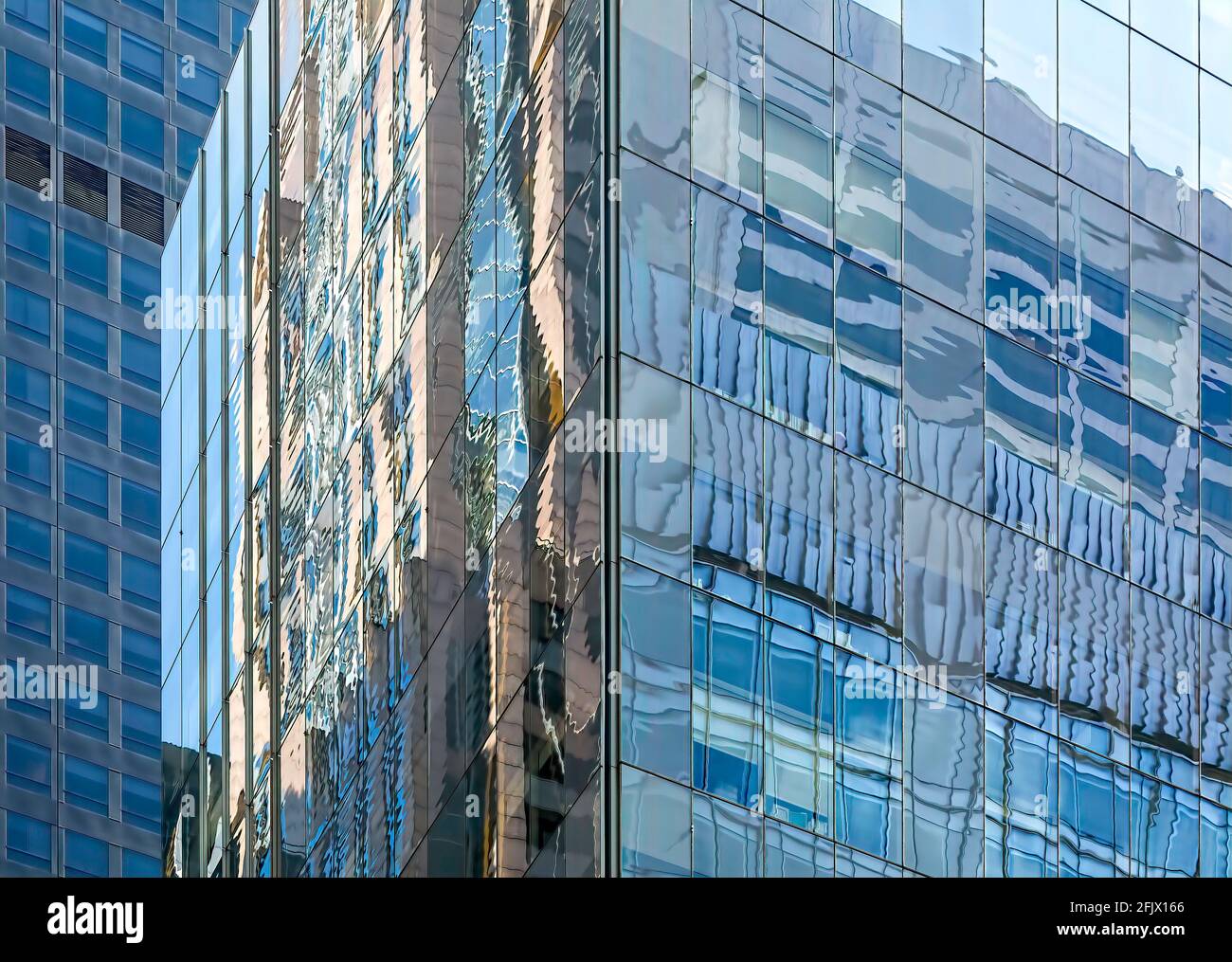 Griglie in vetro riflettente e acciaio nei grattacieli degli uffici di New York City. Foto Stock