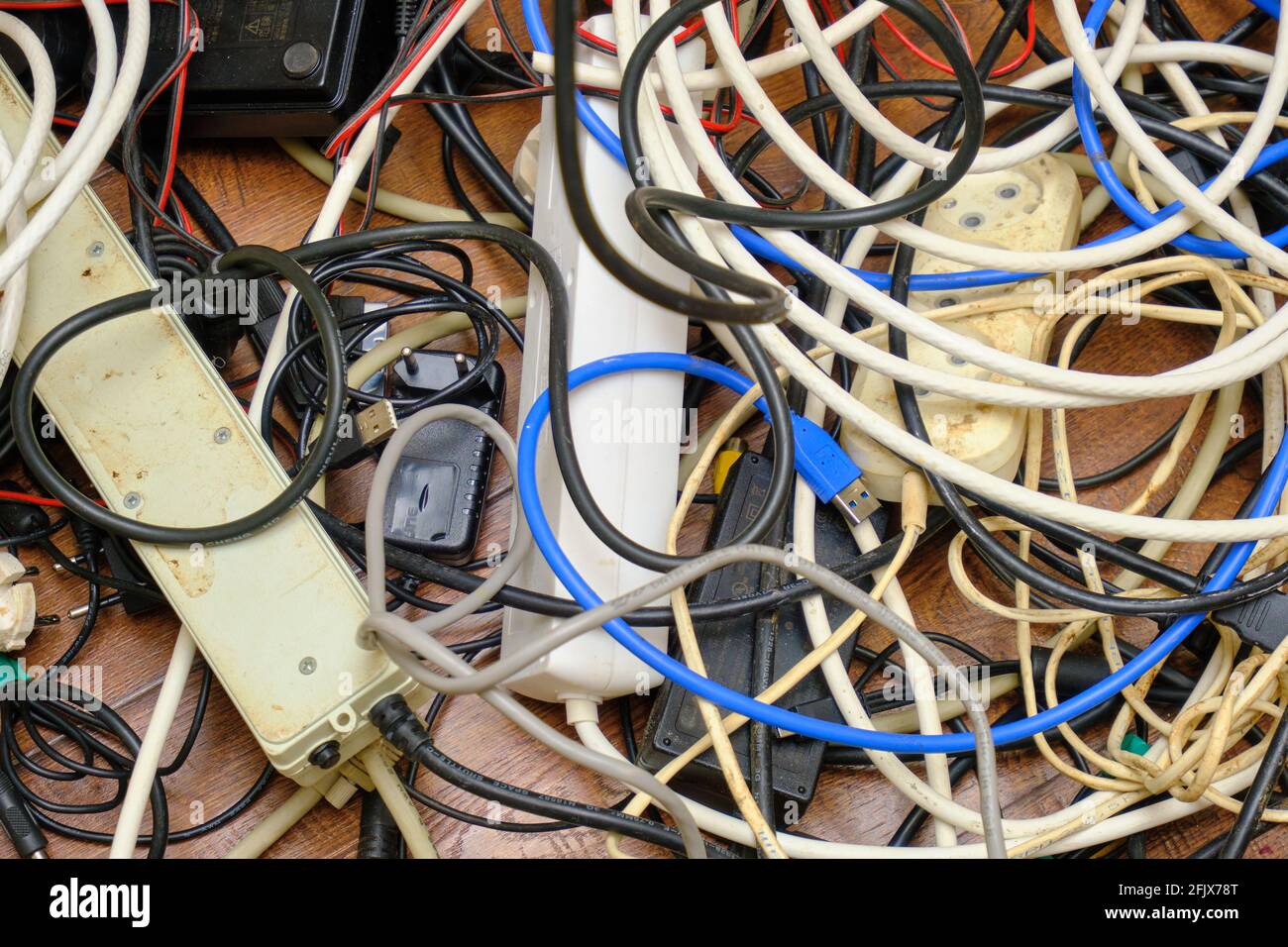 Un groviglio di fili non necessari si trova sul pavimento. Foto Stock
