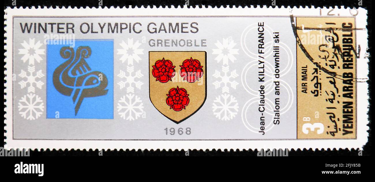 MOSCA, RUSSIA - 16 NOVEMBRE 2019: Francobollo stampato in Yemen mostra Grenoble 1968, stemma dei luoghi della serie dei Giochi Olimpici invernali, Foto Stock