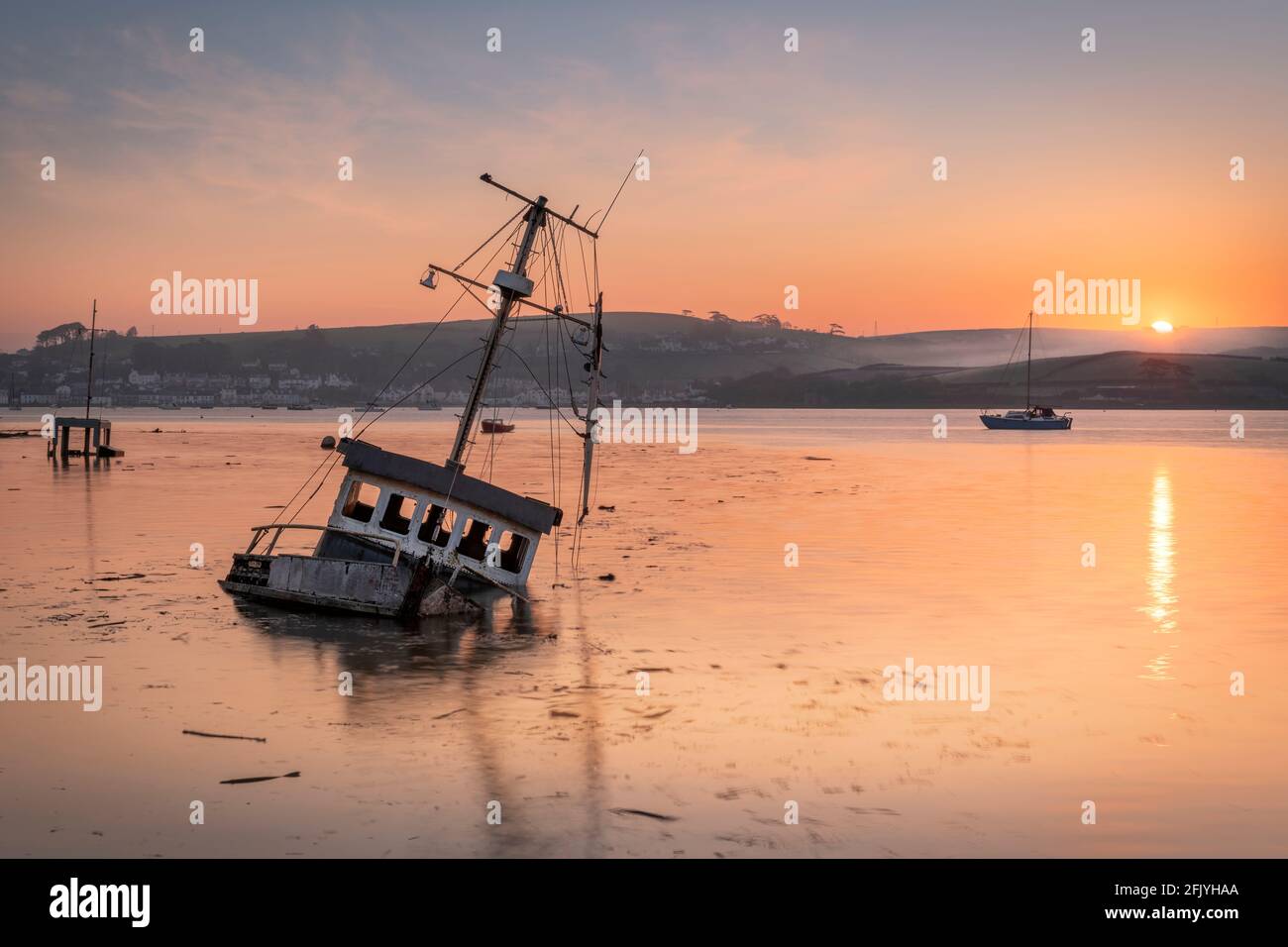 Appletore, North Devon, Inghilterra. Martedì 27 aprile 2021. Regno Unito Meteo. Alta marea su un tranquillo ma freddo fiume Torridge estuario come la marea in arrivo copre lunghe barche abbandonate sulla costa di Appleedore. Oggi sono previsti intervalli di sole e venti leggeri per la costa del Nord Devon. Credit: Terry Mathews/Alamy Live News Foto Stock