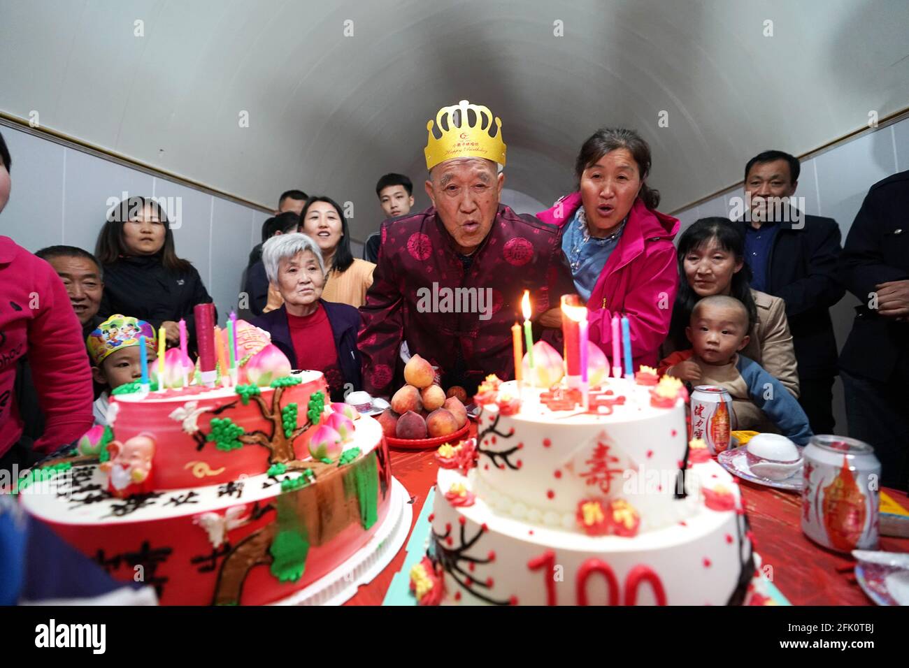 (210427) -- TAIYUAN, 27 aprile 2021 (Xinhua) -- Hu Zaizhong soffia candele sulla sua torta di compleanno al suo banchetto di compleanno al villaggio di Xuejiawan, nella contea di Liulin, nella città di Lyuliang, nella provincia di Shanxi della Cina del nord, il 24 aprile 2021. HU Zaizhong, che ha appena compiuto 100 anni, ricorda vividamente i suoi desideri in diverse fasi della sua vita: Avere cibo e vestiti decenti nei suoi primi giorni, insegnare quanti più alunni possibile nella sua prima età, e godere di un tempo di qualità con la sua famiglia per gli ultimi anni. Tuttavia, Hu ha fatto un nuovo desiderio prima di soffiare le candele sulla sua torta di compleanno. Tutti i membri della famiglia estesa di Hu Foto Stock