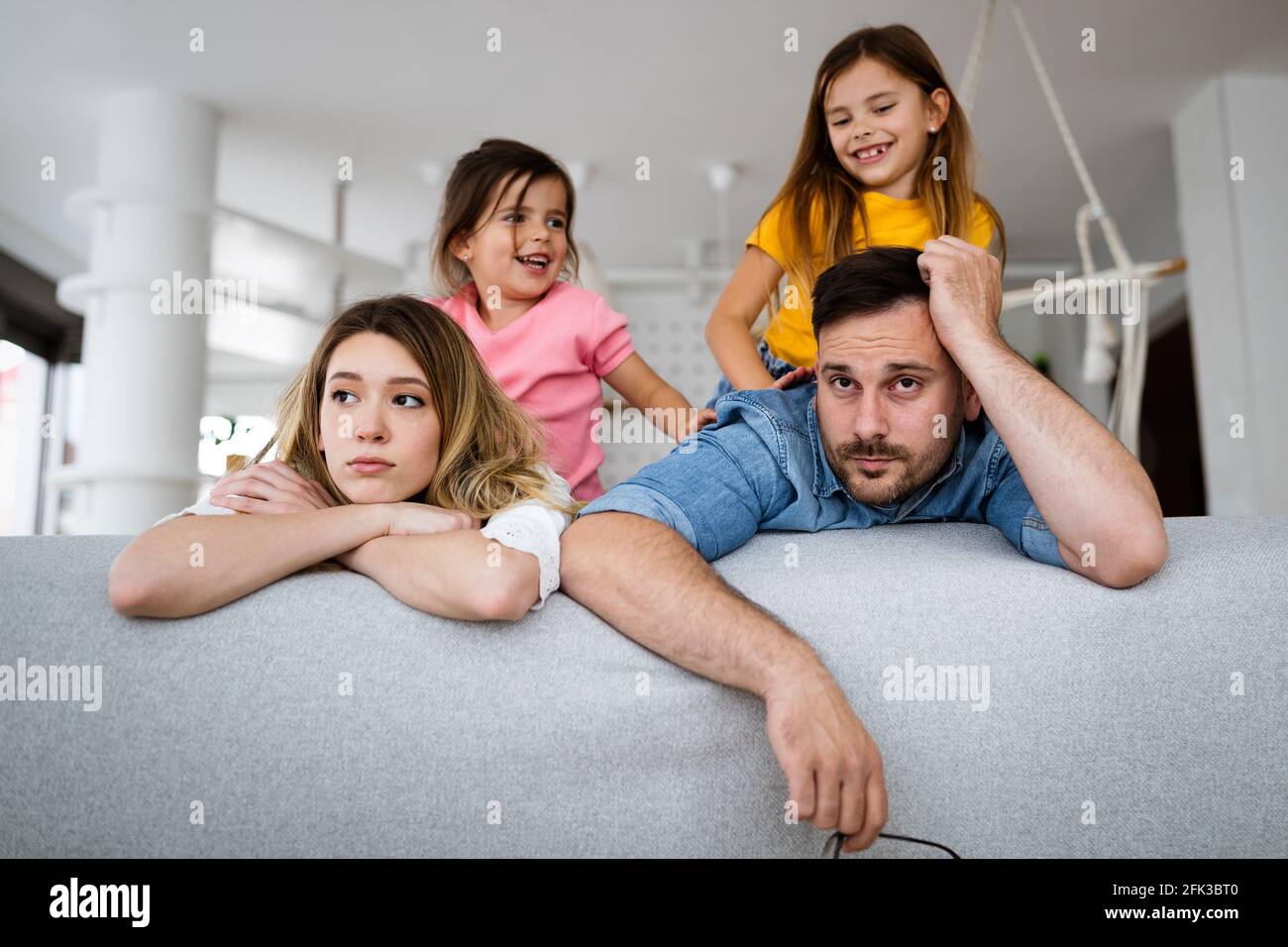 Madre stanca e padre, la coppia si sente seccata di bambini rumorosi Foto Stock