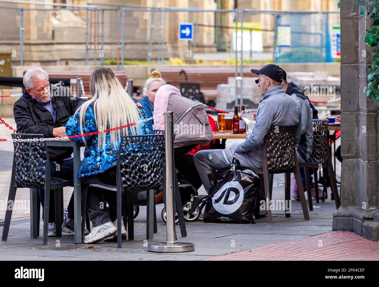 Dundee, Tayside, Scozia, Regno Unito. 28 aprile 2021. Regno Unito tempo: Freddo pomeriggio luminoso attraverso la Scozia nord-orientale con temperature che raggiungono i 9°C. I pub scozzesi hanno finalmente riaperto dopo mesi di rigide restrizioni di blocco del Covid-19. Il governo della Scozia ha permesso alle case pubbliche di tutto il paese di riaprire fino alle 22:00, purché abbiano giardini di birreria all'aperto. I residenti locali approfittano delle nuove norme di blocco e delle condizioni meteorologiche favorevoli per incontrare il pub Wetherspoon`s Counting House per gustare un drink nel centro di Dundee. Credit: Dundee Photographics/Alamy Live Foto Stock