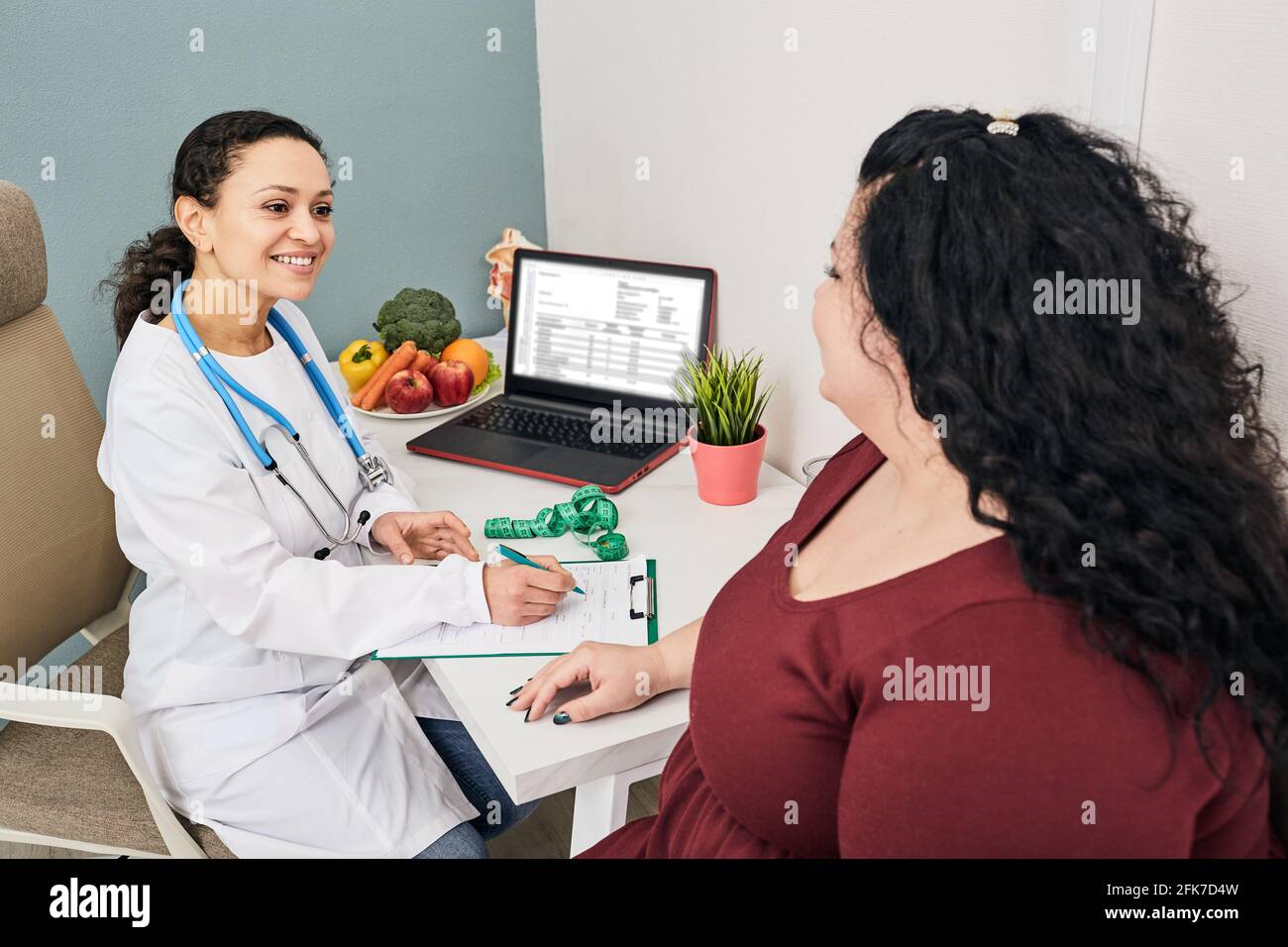 Consulenza nutrizionista. Il dietologo pianifica il programma del pasto per una paziente obesa femminile Foto Stock