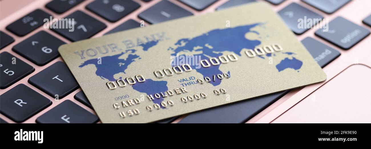 Carta di credito situata sulla tastiera del laptop closeup Foto Stock