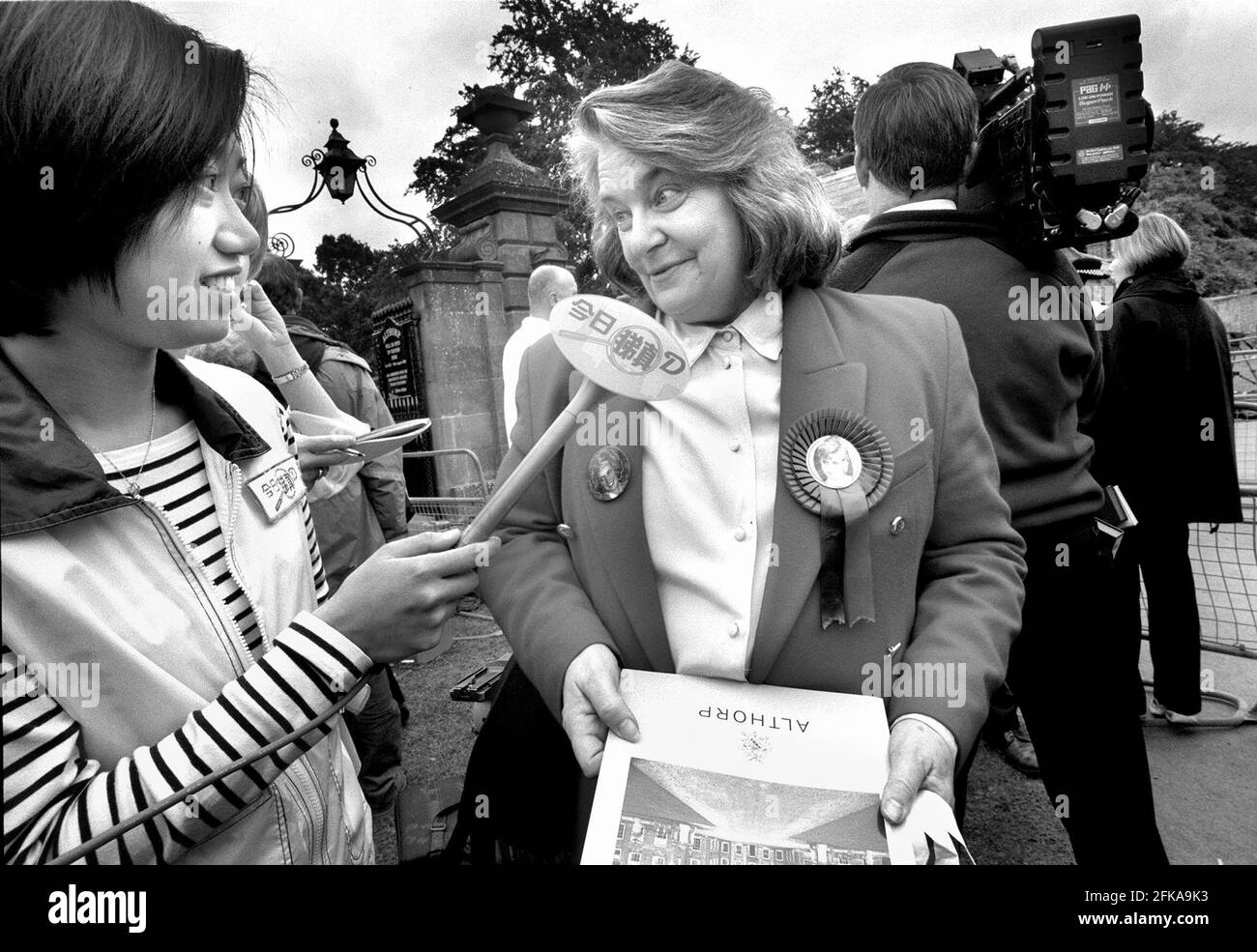 Margaret Tyler parla con un reporter televisivo ad Althorp House. Ha la sua brochure ricordo e indossa la sua rossette Diana. Foto Stock