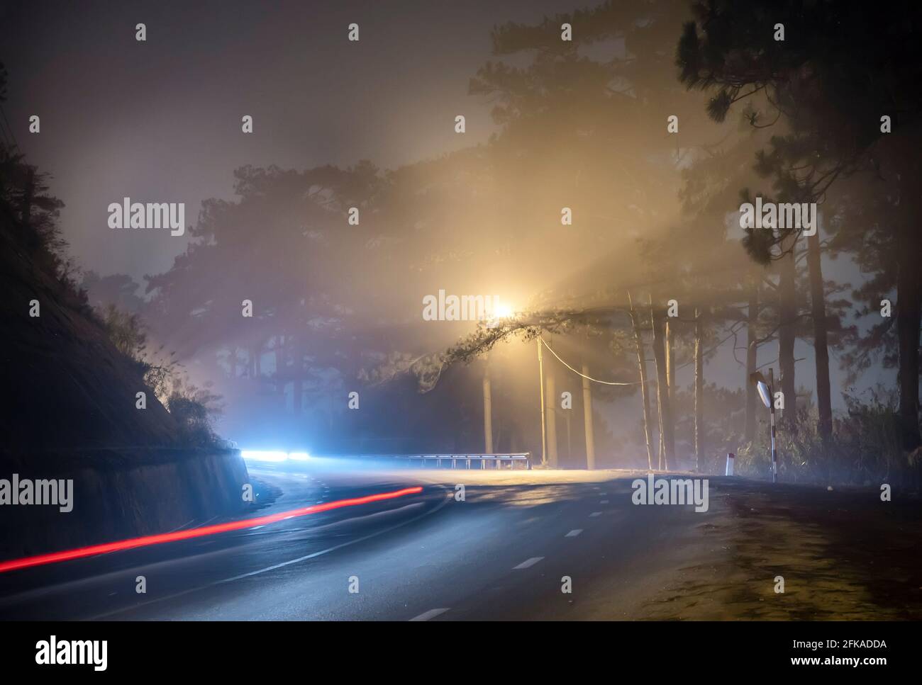 La vista notturna della strada di passaggio è scritta in Vietnamita "nebbia" con magici semafori e traffico sentieri che rendono la notte più bella Foto Stock