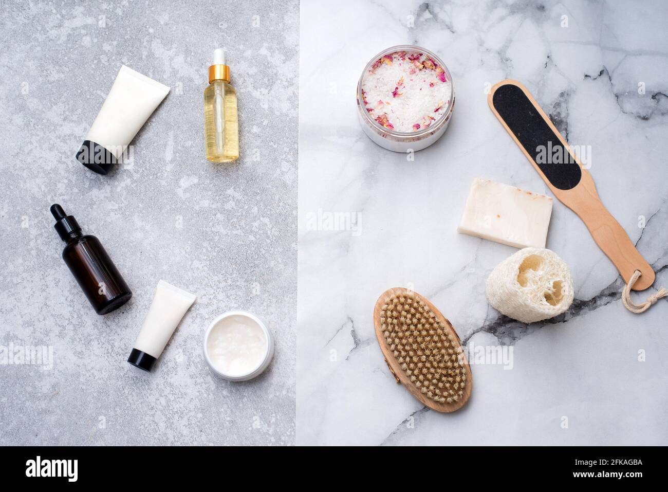 Cosmetici naturali per il bagno su sfondo drey. Sapone, sale da bagno, panno di loofah. Foto Stock
